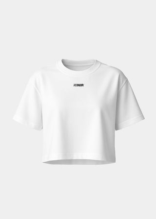 Kinia Studio Tee White front view – women’s cropped performance t-shirt in soft cotton jersey, minimalist logo print, ideal for athleisure and activewear layering.